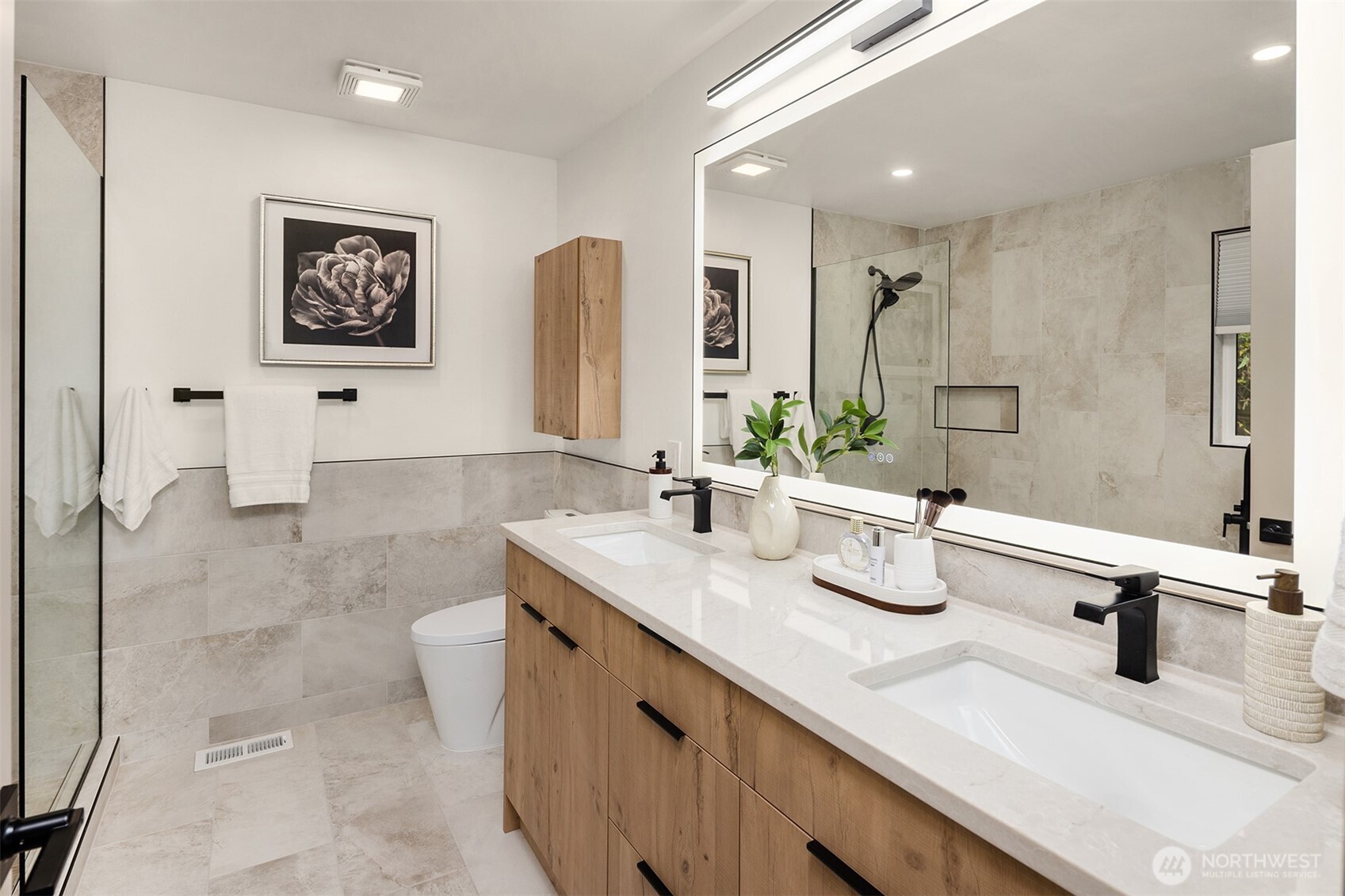 12711 9th Avenue Northwest Seattle, WA 98177 - Photo 20 of 40 a bathroom with double vanity sinks a mirror and shower