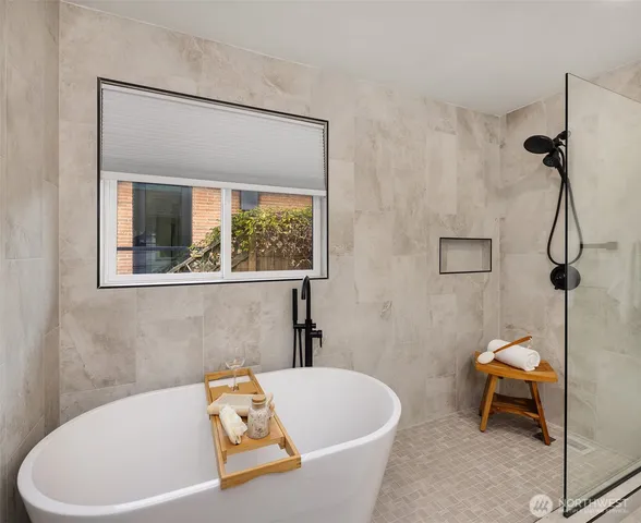 a white bath tub sitting next to a white toilet