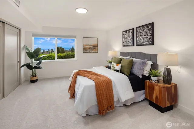 a bedroom with a bed and a painting on the wall