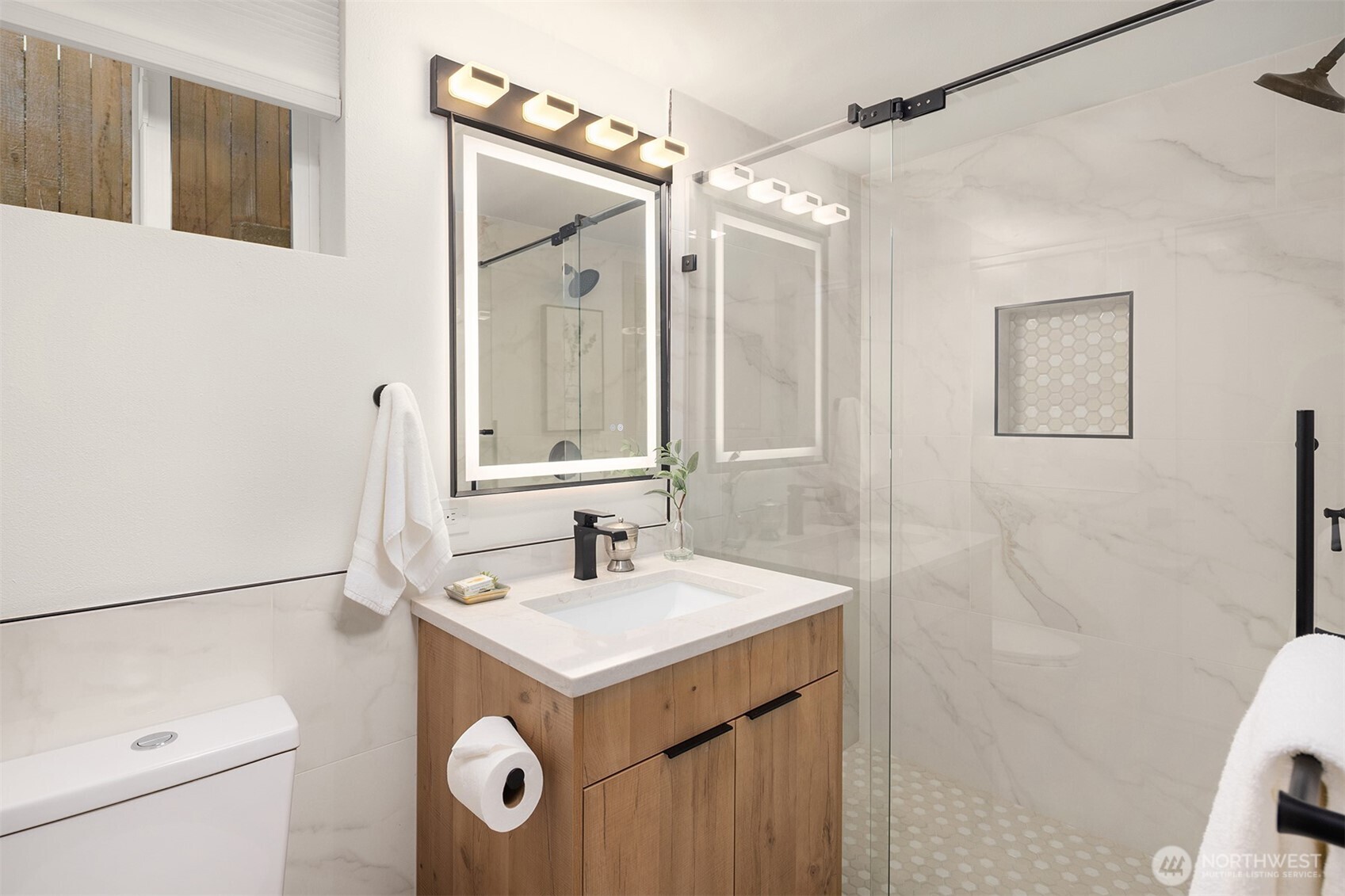 12711 9th Avenue Northwest Seattle, WA 98177 - Photo 31 of 40 a bathroom with a sink a toilet a mirror a vanity and shower