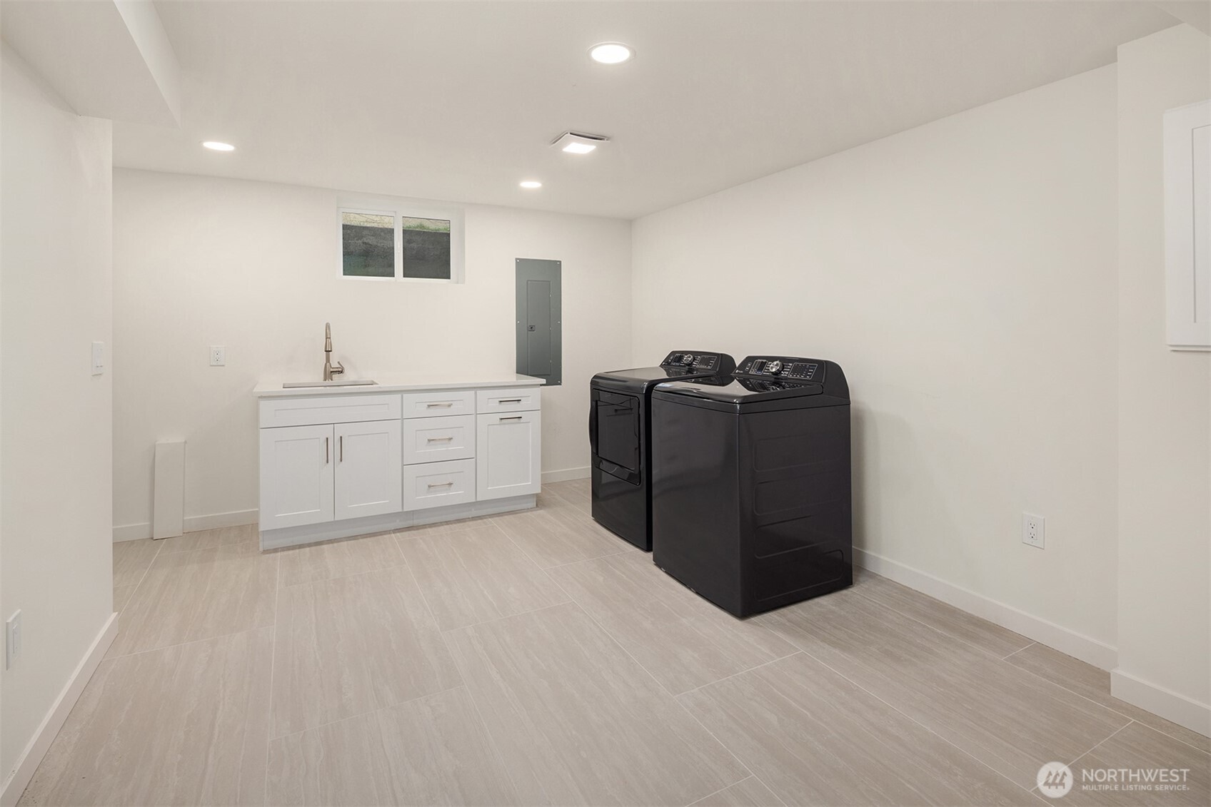12711 9th Avenue Northwest Seattle, WA 98177 - Photo 32 of 40 a kitchen with granite countertop white cabinets and refrigerator