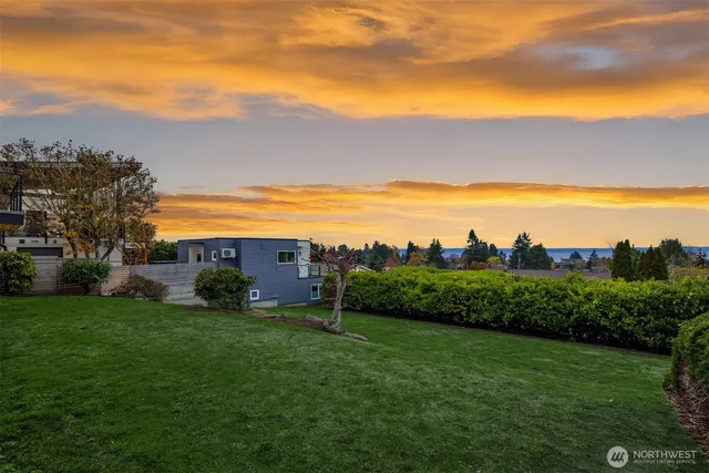 a view of a lake and green valley