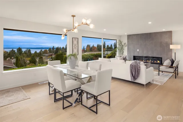 a living room with furniture a flat screen tv and a large window