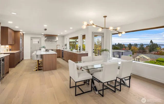 a dining room with wooden floor a chandelier a wooden table and chairs