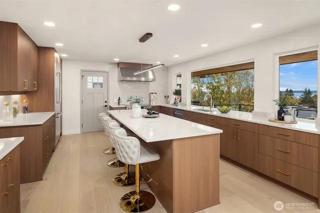 a kitchen with a sink a counter top space appliances and cabinets