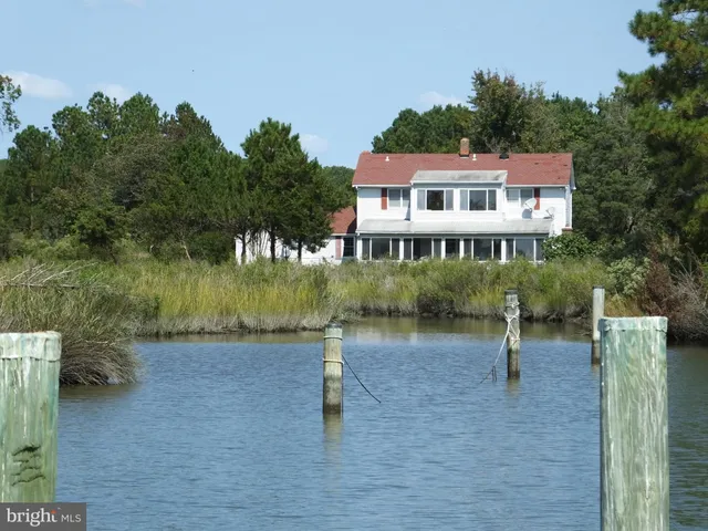 a view of a lake with houses in the back