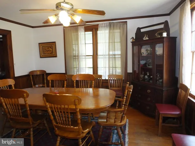 a bedroom with a bed and teddy bear on bed