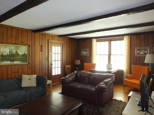 a bedroom with a bed and glass window