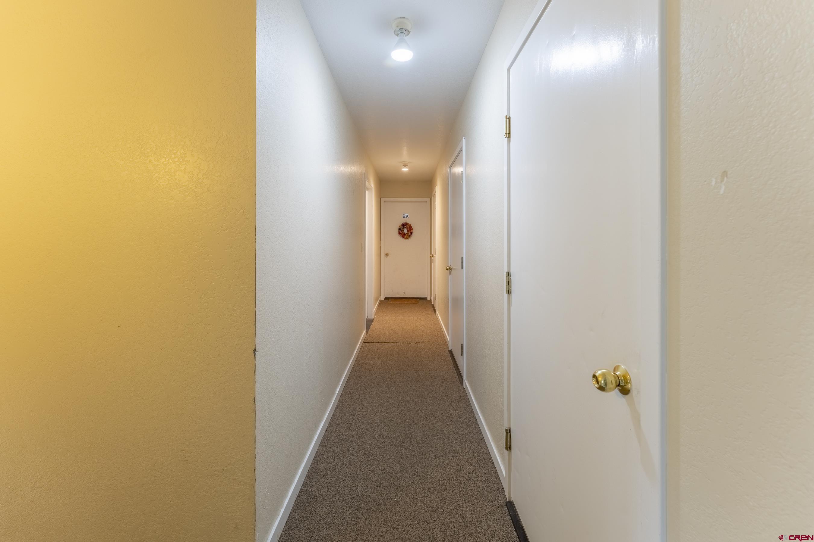 309 Belleview Avenue, Unit 2C Crested Butte, CO 81224 - Photo 16 of 17 a view of a hallway with wooden floor