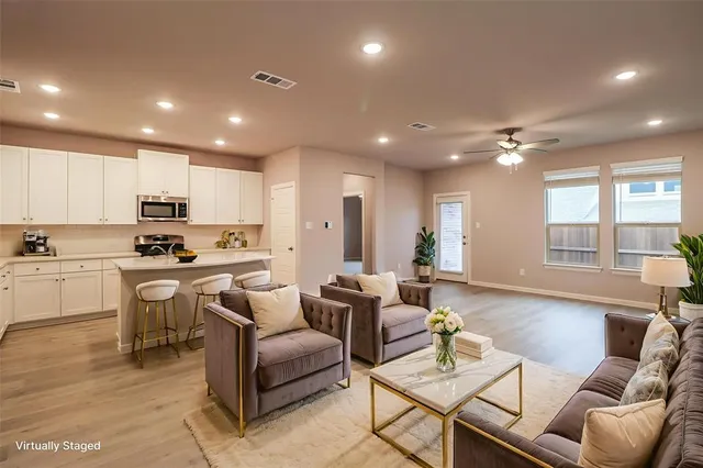 a living room with kitchen island furniture and a large window