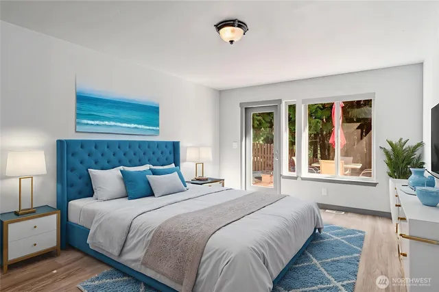 a bedroom with a large bed and a window