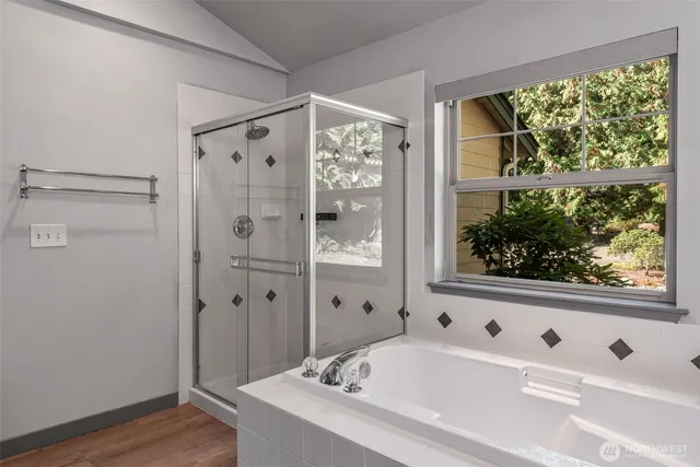 a bathroom with a bathtub and a shower