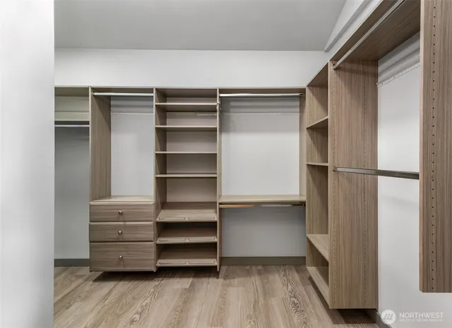 a view of walk in closet with empty racks
