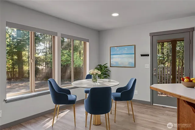 a dining room with furniture window and wooden floor