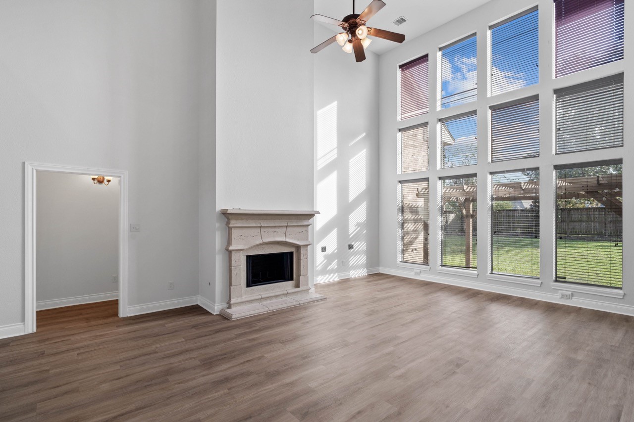 26411 Ridgefield Park Lane Cypress, TX 77433 - Photo 12 of 50 a view of empty room with wooden floor and fireplace