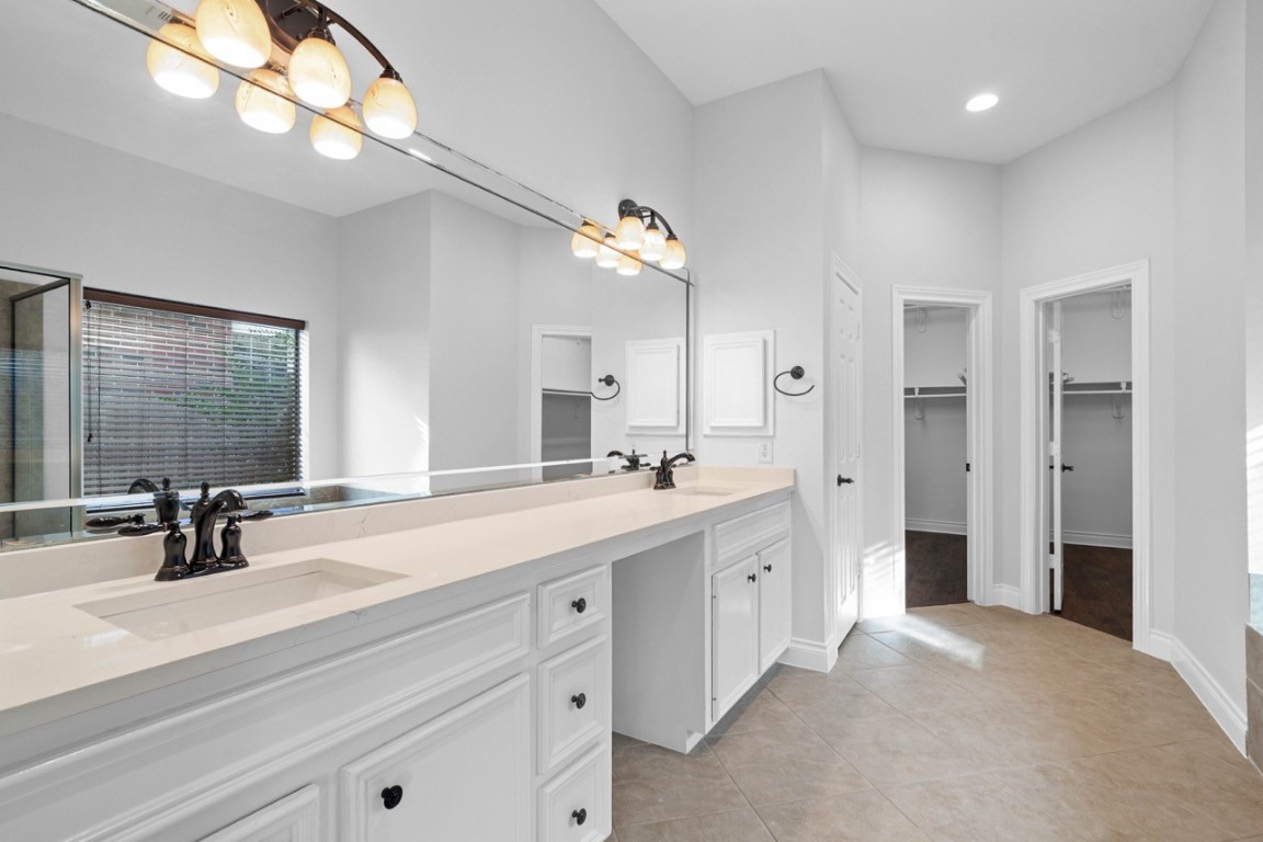 26411 Ridgefield Park Lane Cypress, TX 77433 - Photo 28 of 50 a bathroom with a sink double vanity and a mirror