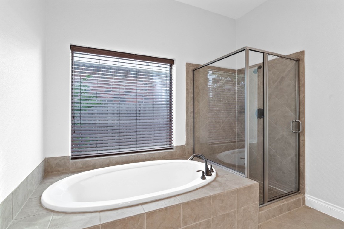 26411 Ridgefield Park Lane Cypress, TX 77433 - Photo 29 of 50 a bathroom with a bathtub and shower
