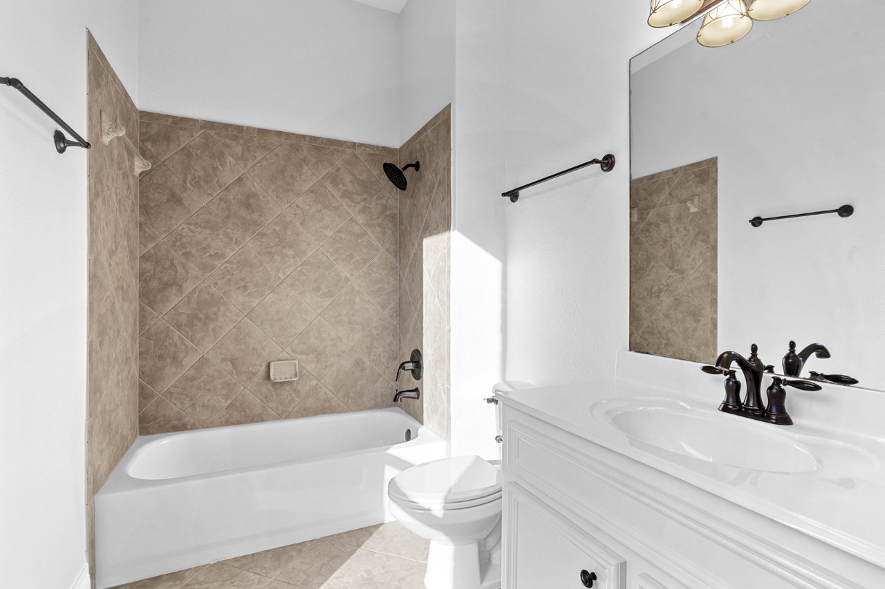 26411 Ridgefield Park Lane Cypress, TX 77433 - Photo 32 of 50 a bathroom with a sink a toilet and a bathtub