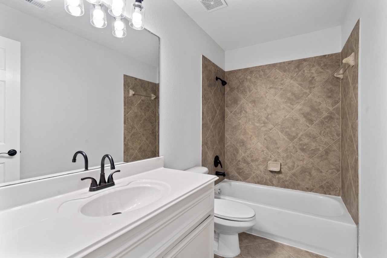 26411 Ridgefield Park Lane Cypress, TX 77433 - Photo 37 of 50 a bathroom with a sink a toilet and shower