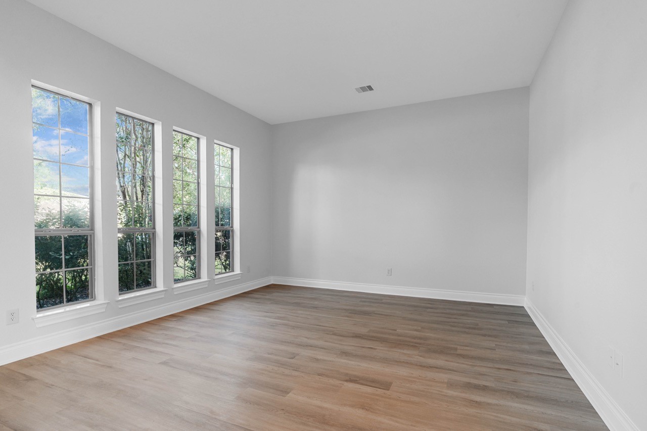 26411 Ridgefield Park Lane Cypress, TX 77433 - Photo 4 of 50 a view of an empty room with wooden floor and a window
