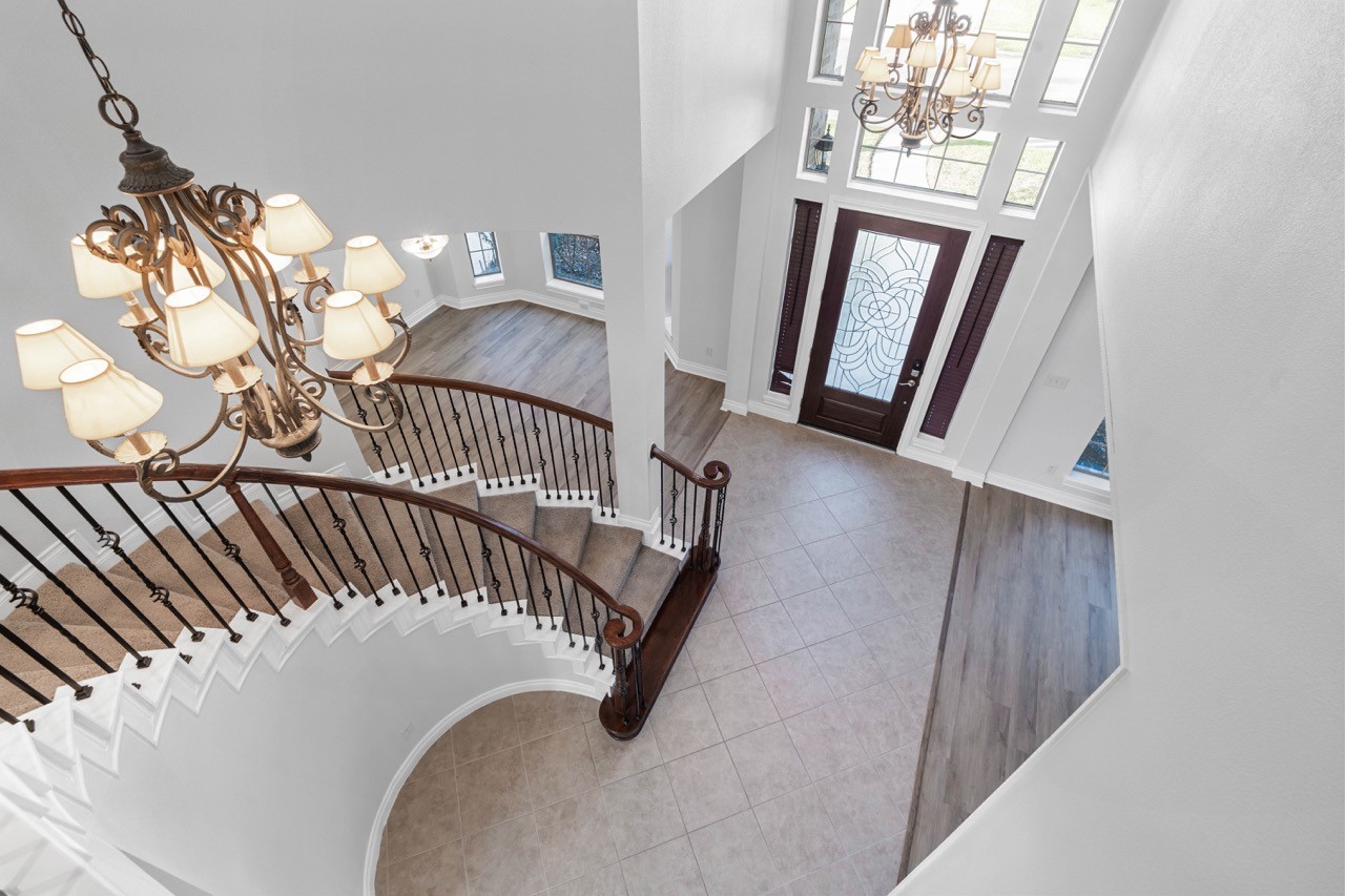 26411 Ridgefield Park Lane Cypress, TX 77433 - Photo 42 of 50 a view of staircase with railing and a chandelier