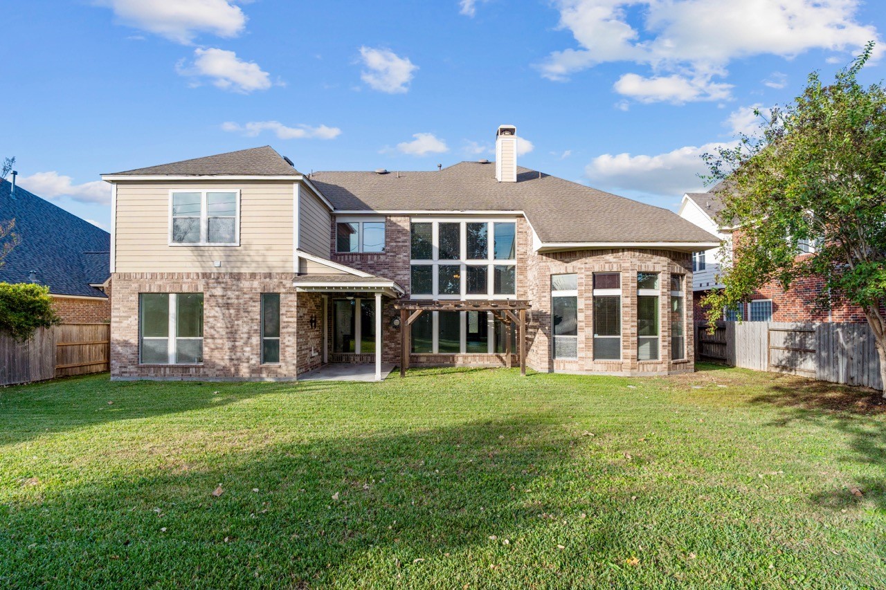 26411 Ridgefield Park Lane Cypress, TX 77433 - Photo 46 of 50 a view of a house with a yard