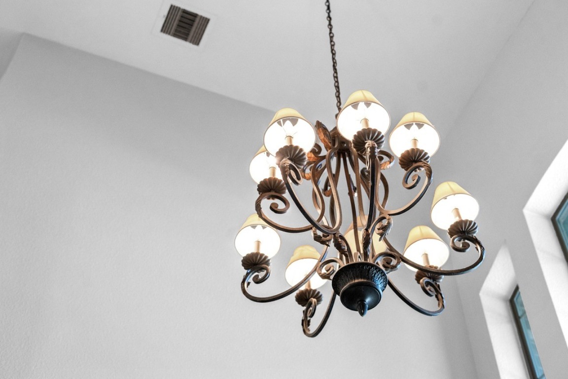 26411 Ridgefield Park Lane Cypress, TX 77433 - Photo 47 of 50 Elegant chandelier with multiple lights, adding a classic touch to the high-ceilinged room.