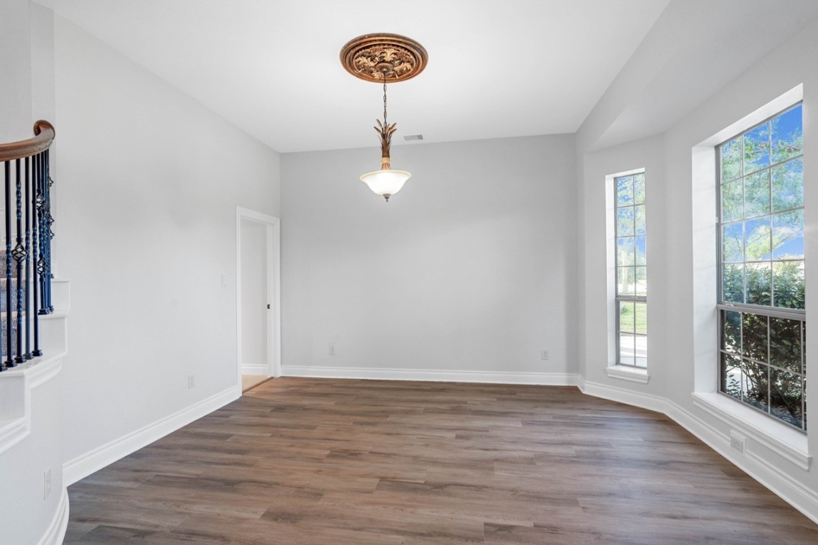 26411 Ridgefield Park Lane Cypress, TX 77433 - Photo 6 of 50 a view of an empty room with a window and wooden floor