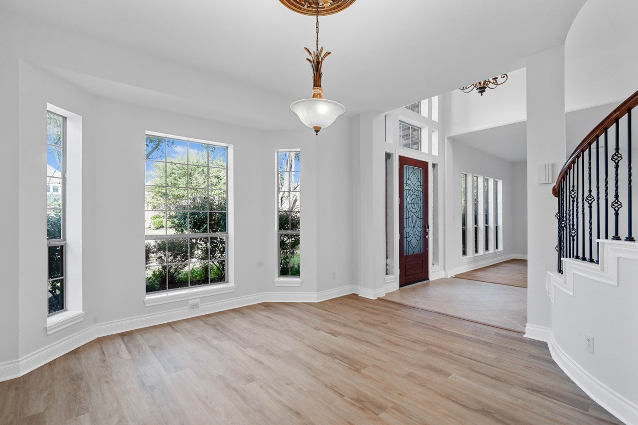 26411 Ridgefield Park Lane Cypress, TX 77433 - Photo 8 of 50 a view of an empty room with wooden floor and a window