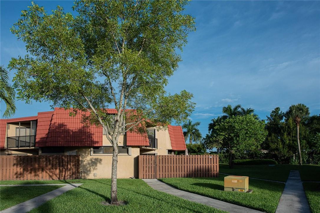 8116 Thames Boulevard, Unit A Boca Raton, FL 33433 - Photo 1 of 27 a front view of a house with a garden and a tree