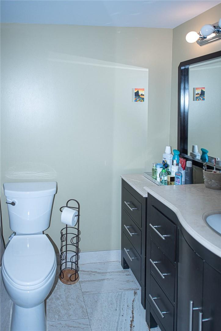 8116 Thames Boulevard, Unit A Boca Raton, FL 33433 - Photo 11 of 27 a bathroom with a toilet sink and mirror