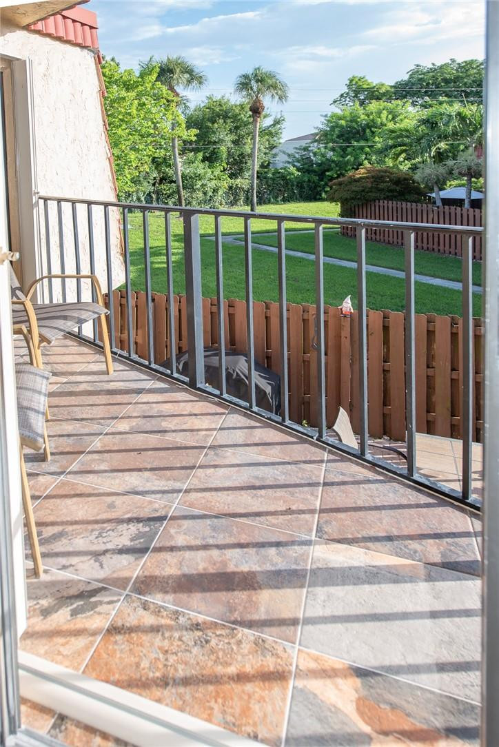 8116 Thames Boulevard, Unit A Boca Raton, FL 33433 - Photo 15 of 27 a view of a balcony with a floor to ceiling window and wooden fence