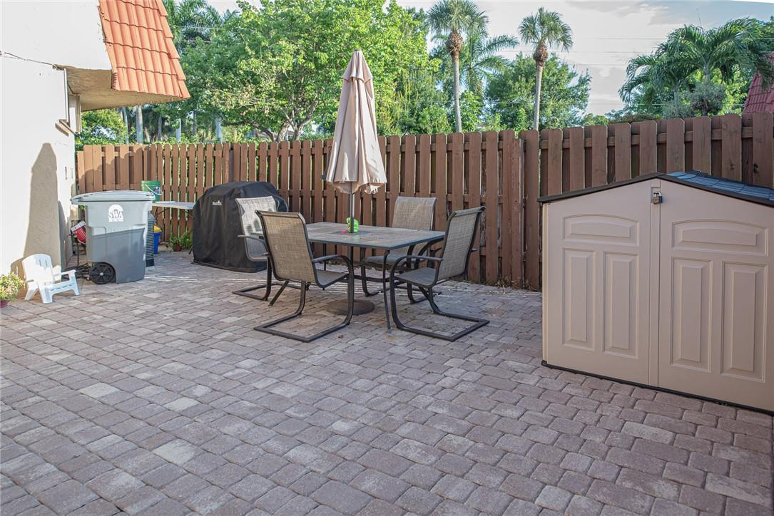 8116 Thames Boulevard, Unit A Boca Raton, FL 33433 - Photo 2 of 27 a view of a chairs and table in backyard