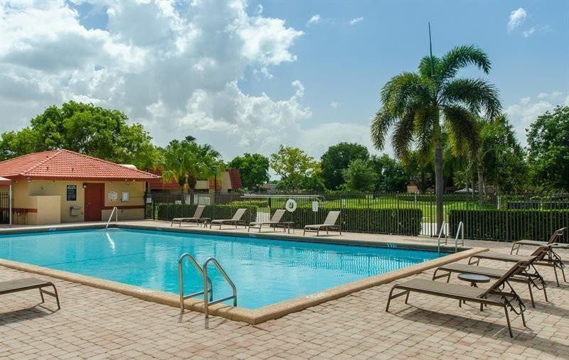 8116 Thames Boulevard, Unit A Boca Raton, FL 33433 - Photo 22 of 27 a view of a swimming pool with a patio and a yard