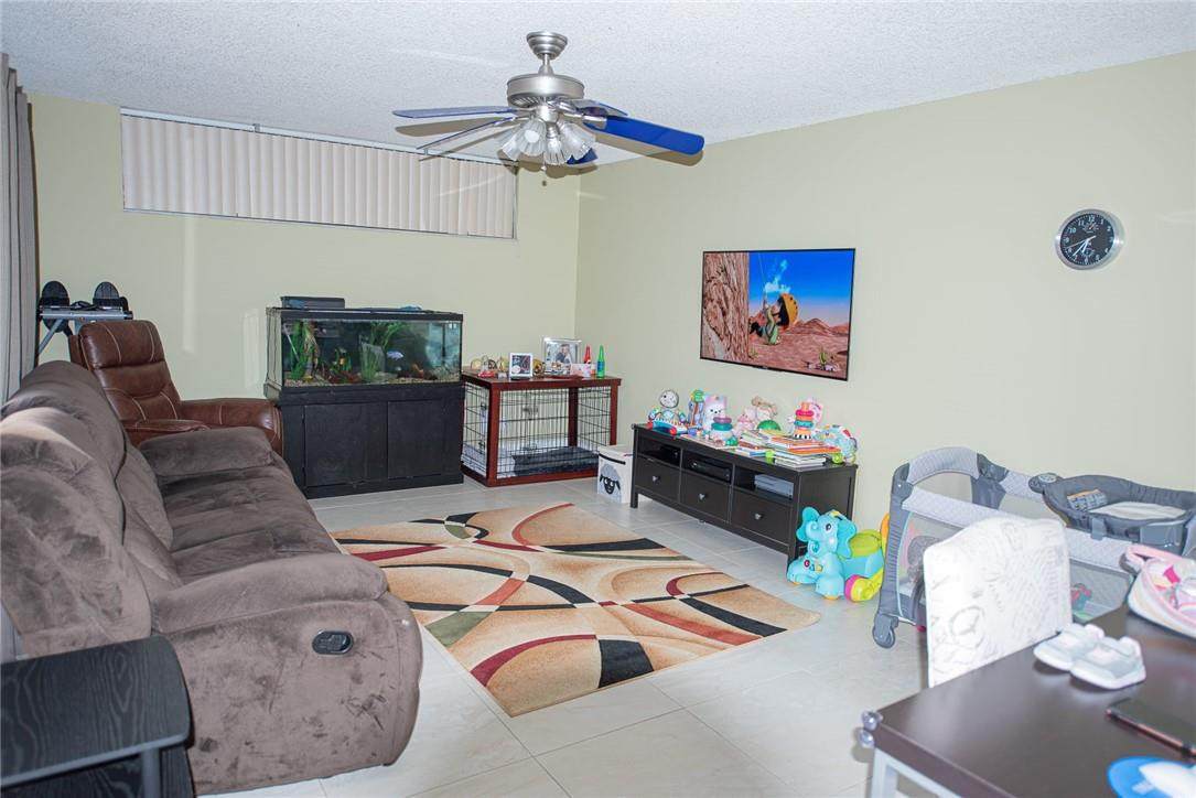 8116 Thames Boulevard, Unit A Boca Raton, FL 33433 - Photo 3 of 27 a living room with furniture and a flat screen tv