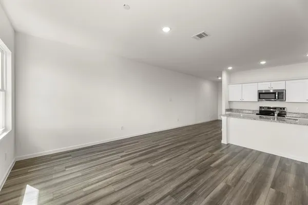 a large kitchen with stainless steel appliances kitchen island a sink a stove a refrigerator a center island and a stove