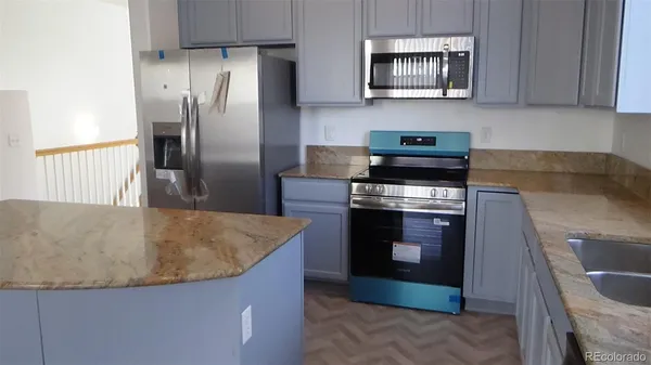 a stove top oven sitting inside of a kitchen