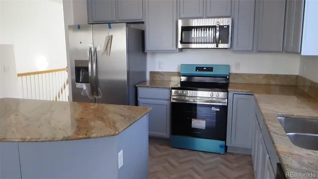 a stove top oven sitting inside of a kitchen