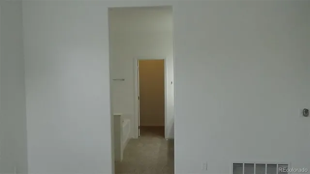 a white toilet sitting next to a shower