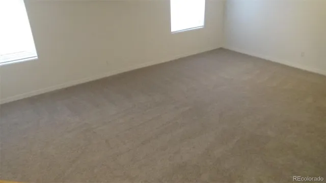 a view of an empty room with stairs