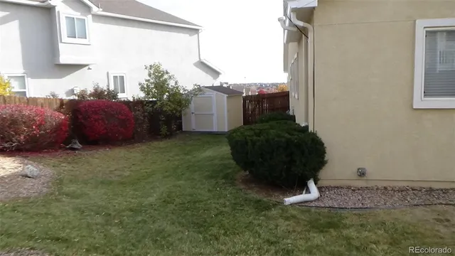 a backyard of a house with table and chairs
