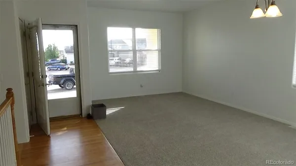 a view of staircase with wooden floor and a rug