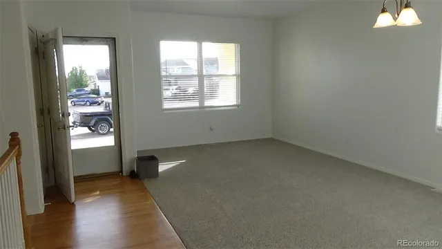 a view of staircase with wooden floor and a rug
