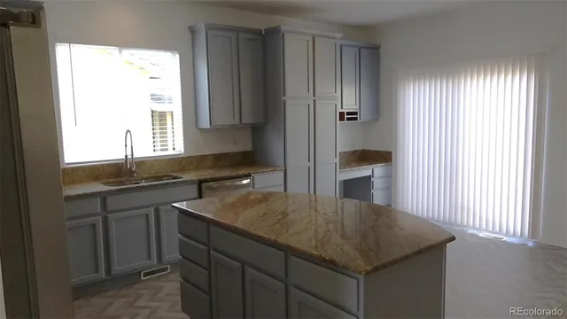 a kitchen with a sink and cabinets