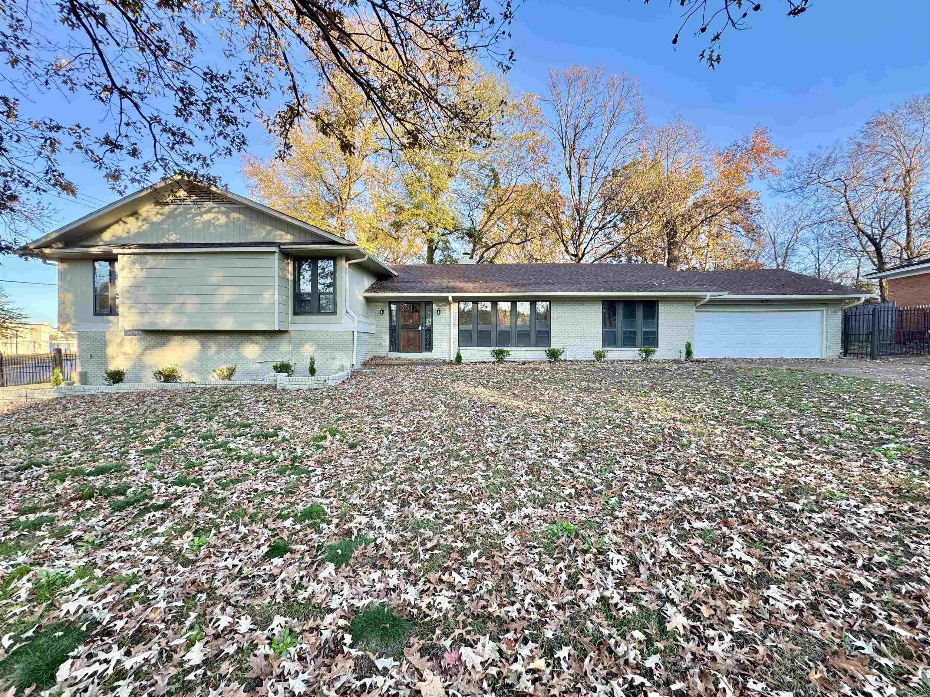 View of front of property with brick siding and an attached garage