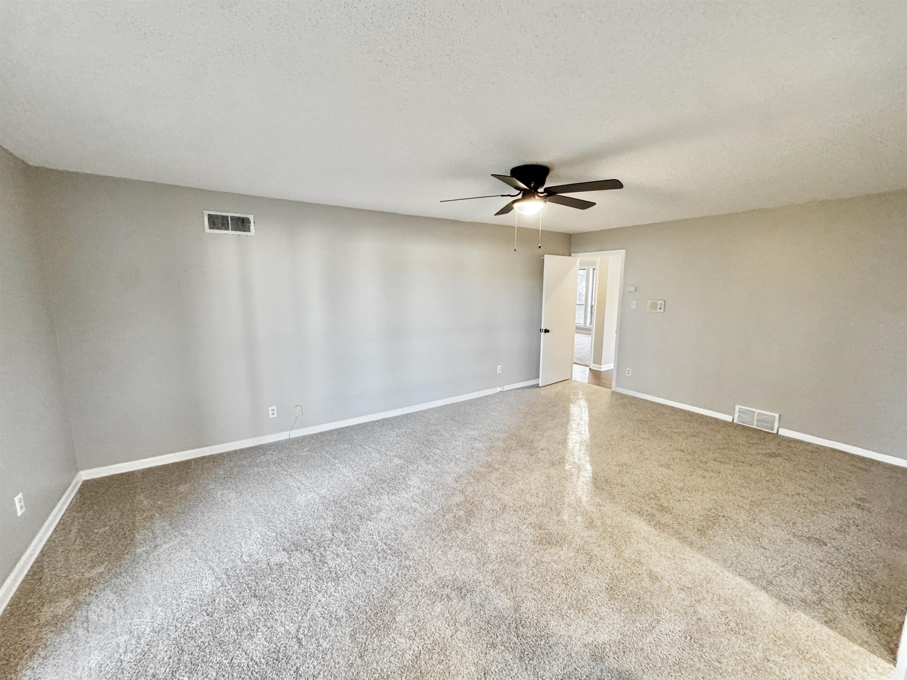 3836 Birchleaf Road Memphis, TN 38116 - Photo 18 of 40 Empty room featuring a textured ceiling and a ceiling fan