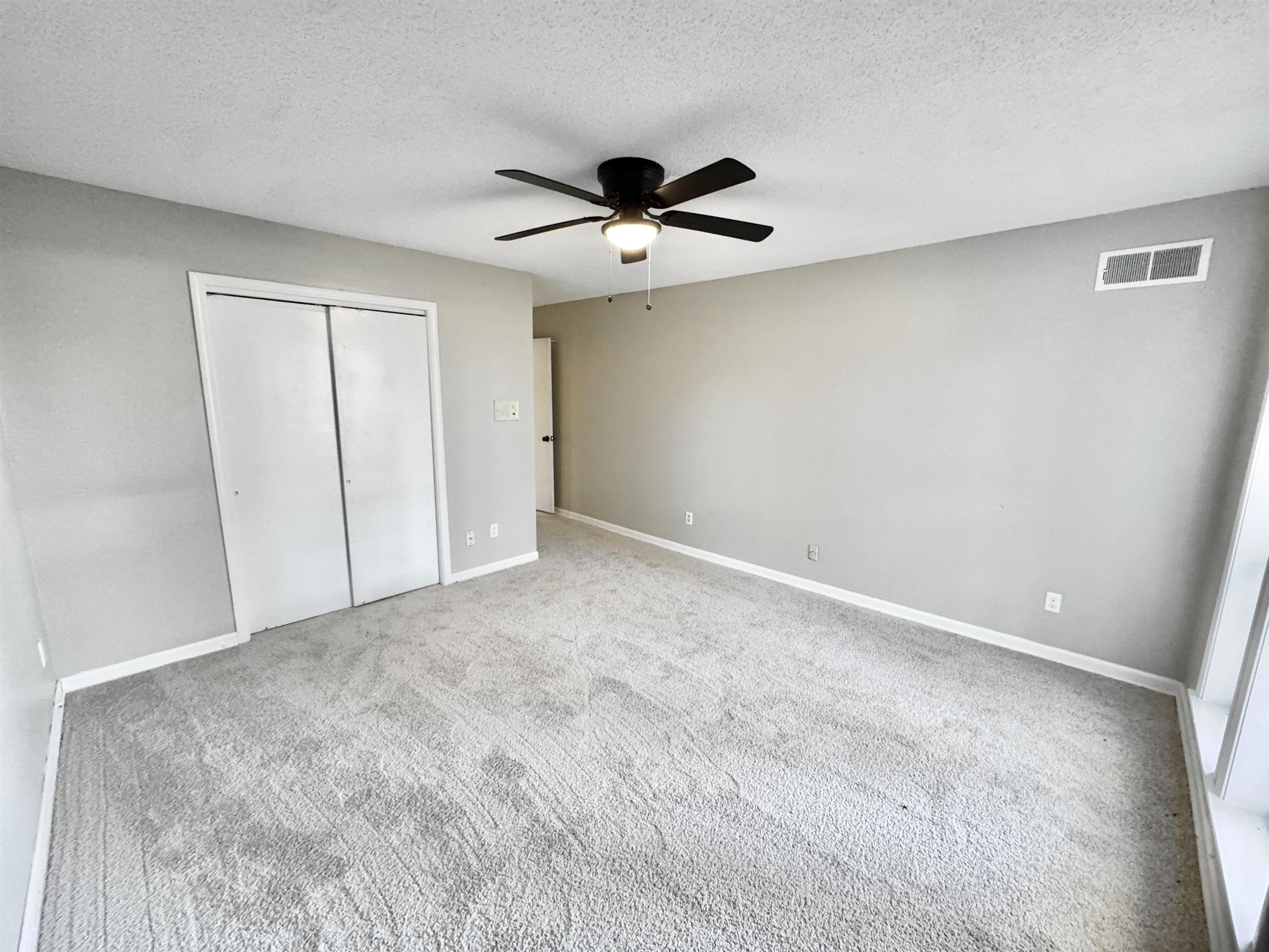 3836 Birchleaf Road Memphis, TN 38116 - Photo 19 of 40 Unfurnished bedroom featuring a closet, a textured ceiling, carpet floors, and a ceiling fan