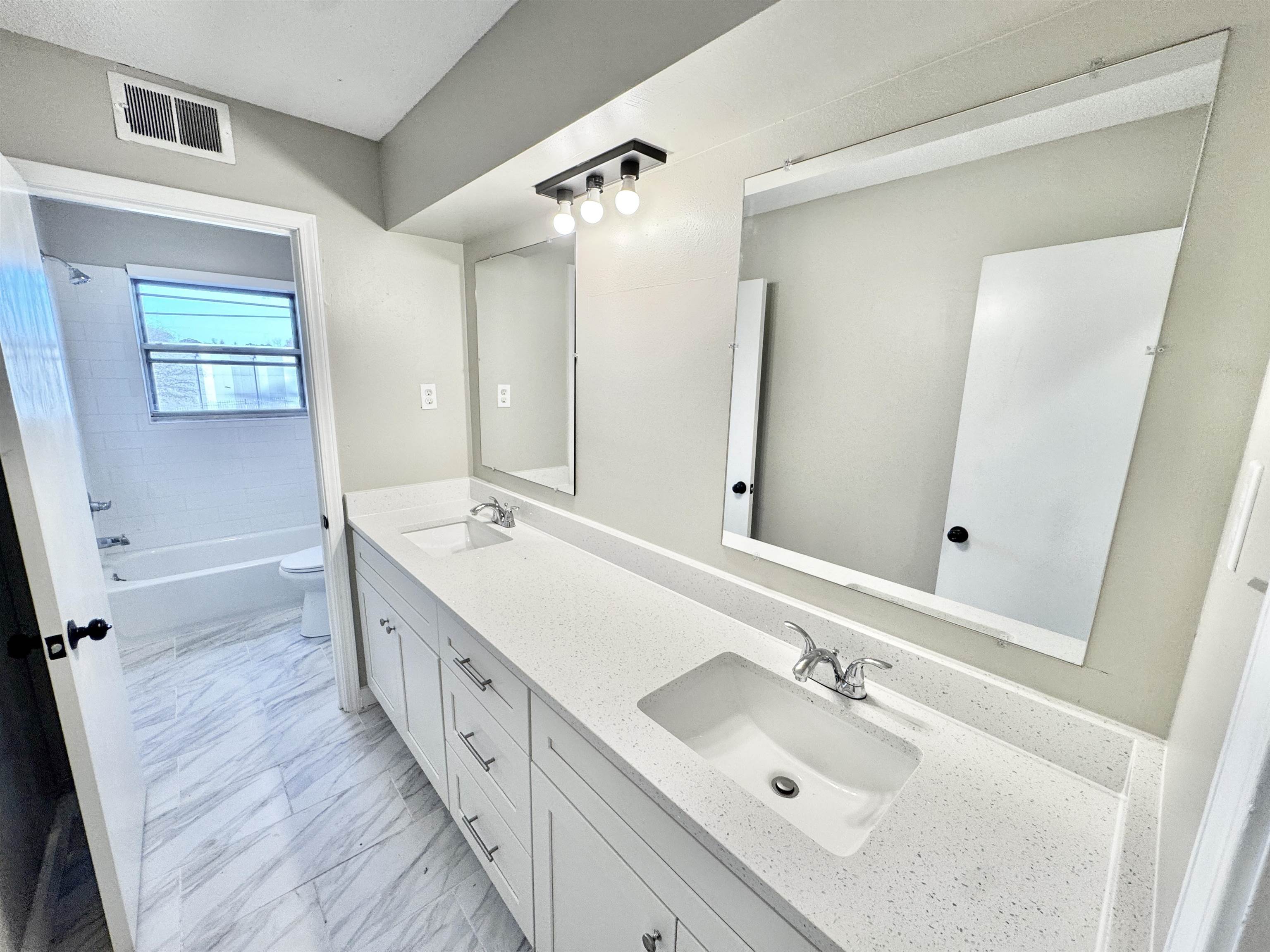 3836 Birchleaf Road Memphis, TN 38116 - Photo 22 of 40 Bathroom featuring double vanity, light marble finish floors, and shower / bath combination