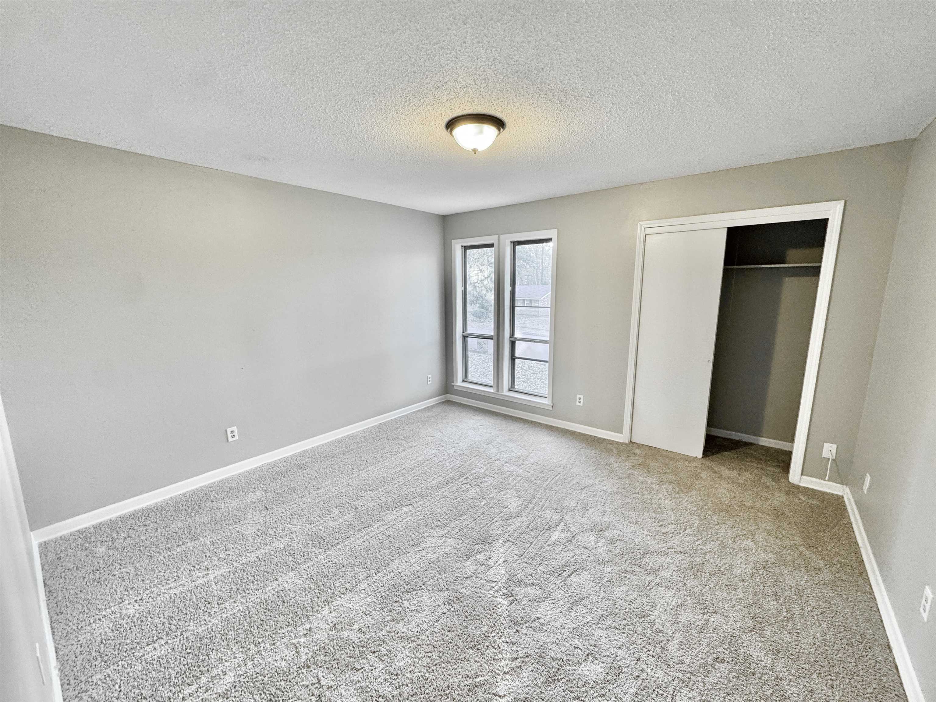 3836 Birchleaf Road Memphis, TN 38116 - Photo 22 of 40 Unfurnished bedroom featuring carpet, a textured ceiling, and a closet