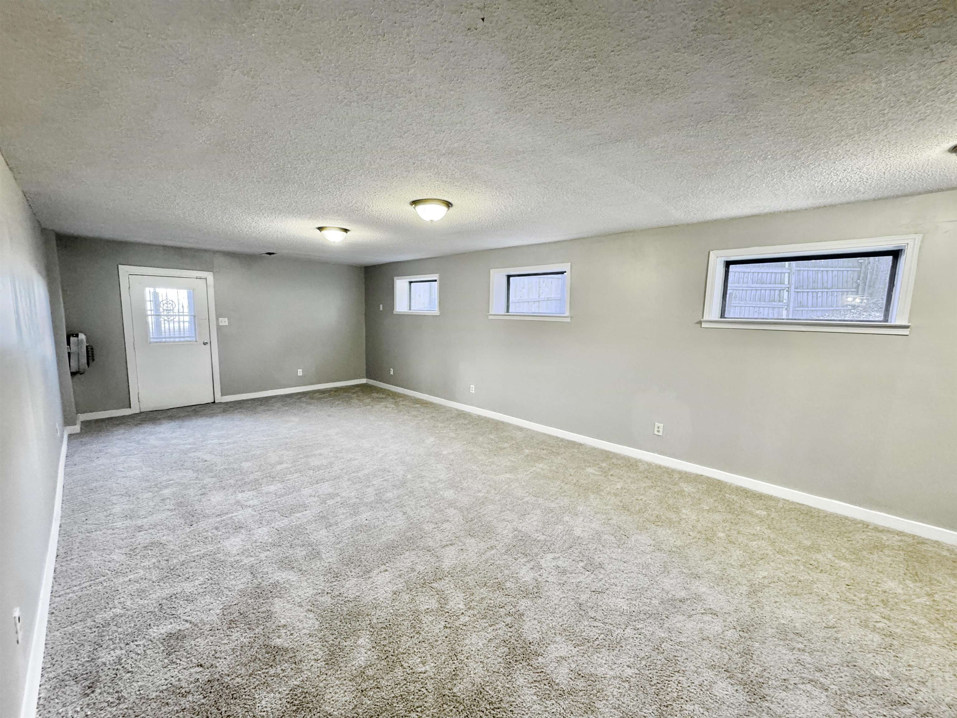 3836 Birchleaf Road Memphis, TN 38116 - Photo 29 of 40 Carpeted empty room featuring a textured ceiling and baseboards